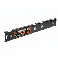 Black metal spacer bar with measurement markings on a white background